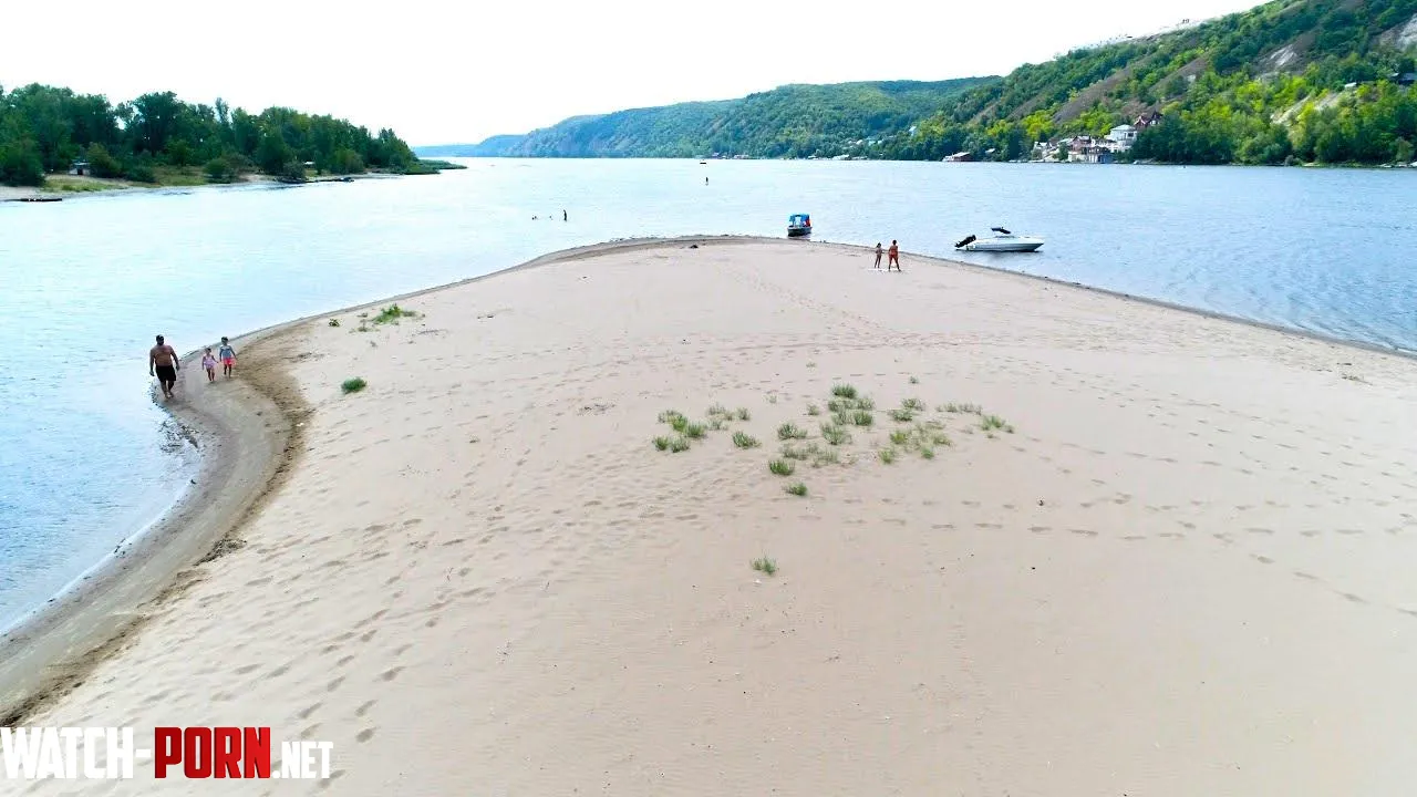 Small white sand beach on an island on the river by Stock-Olive